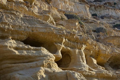 Neolithic caves, former hippie paradise, eroded cliffs with natural caves and footbridges, arid