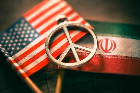 Flags of USA and Iran with peace symbols, symbolic photo peace agreement, photo montage +++