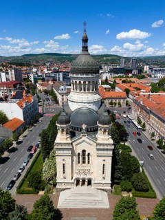 Central church with a distinctive tower in the midst of a lively urban landscape under slightly
