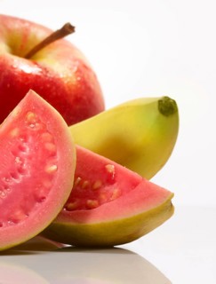 Apple, banana and guava against white background, studio shot