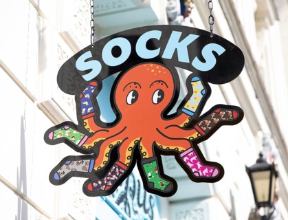 Wall octopus sign for Socktopus retail shop store brand in city centre of Exeter, Devon, England,
