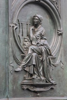 Grey monochrome relief, musician with lyre, allegory for opera Fidelio, symbol, composition, harp