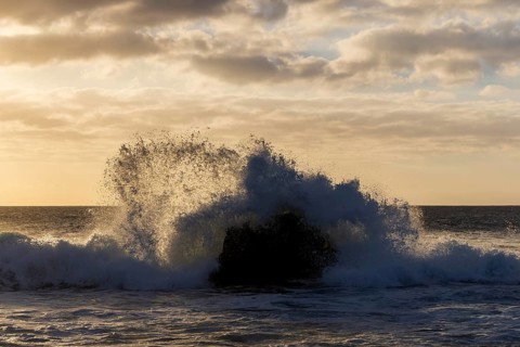 Lanzarote, Canary Islands, Spain, Europe, Los Hervideros, waves hitting a rock in the sea at sunset