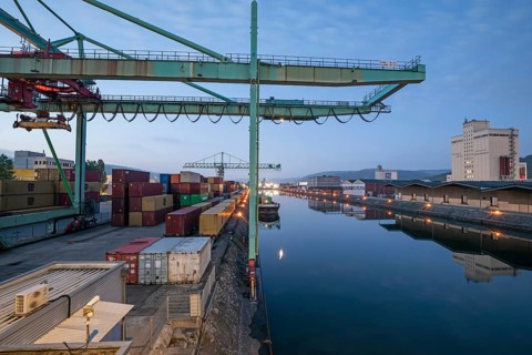 8.5.2026: Container terminal at Stuttgart harbor with cranes and barge under moonlight. Stuttgart,