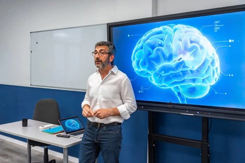 Professor standing and delivering a scientific lecture on human brain anatomy and neurological