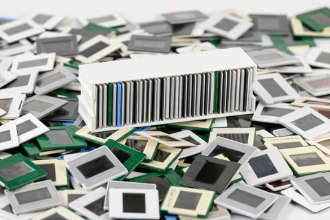 A colorful pile of slides surrounds a filled white slide holder