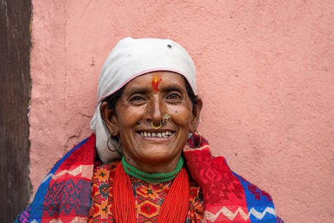 Portrait, friendly smiling elderly woman with traditional jewelry, Hindu ethnic group, Himalayas,