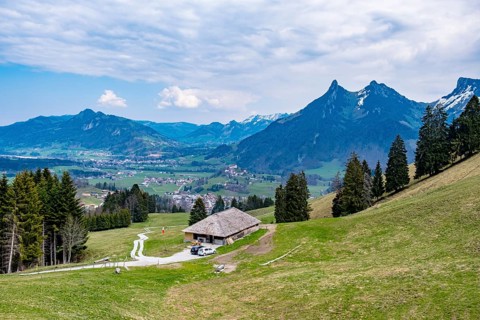 Landscape with mountains, a hut and vast meadows under a blue sky, Enney, Canton of Fribourg,