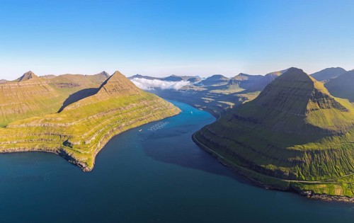 Panoramic view of Funningsfjørður near Funningur on Eysturoy island, fjord with steep mountains,