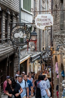 Mass tourism in the historic alleys of Rocky Island, Le Mont Saint Michel monastery island, tourist