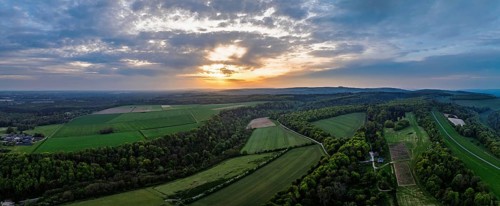 Sunset over Arundel fields and farms from a drone, Arundel, West Sussex, England, United Kingdom