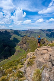 Female mountaineer at the summit of Cathedral Peak or Cathedralpiek or Mponjwana, Drakensberg,
