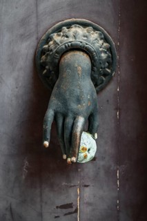 Old French door knocker with hand and apple on front door in Pèrigueux, Dordogne, France
