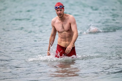 Swimmer comes out of the water after the swimming stage, Tegernsee Triathlon, Tegernsee, Upper