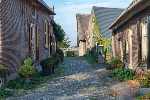 Street with brick houses and cobblestones in the small town of Bronkhorst, Bronckhorst