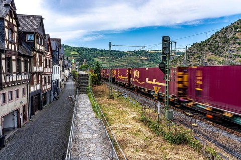 Freight train, in the Upper Middle Rhine Valley, runs directly in front of the residential