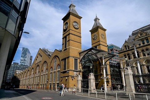 Travelers in front of Liverpool Street Station, Victorian-era building designed by engineer Edward