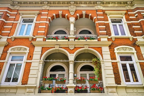 Balconies with flower boxes of a residential and commercial building in the Sachsentor in