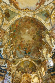 Magnificent baroque hall with gilded decorations and ornate frescoes on the ceiling, Hofkirche,