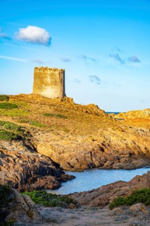 An old tower at the coast at Marinedda at sunset, Sardinia, Italy