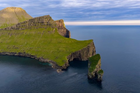 Drangarnir rock formation on the steep coast of the island of Vágar, Faroe Islands, Denmark