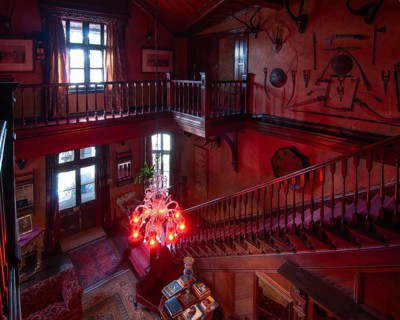 Entrance area with weapons and hunting trophies, Chapslee Hotel, former summer residence of Raja of