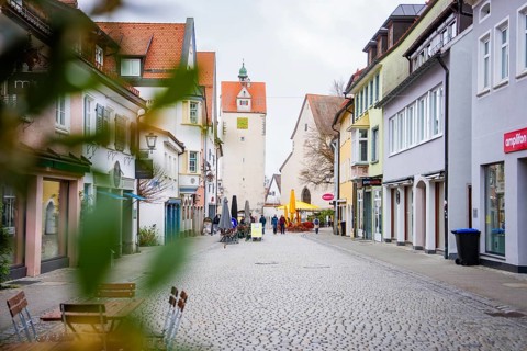 Urban scene with historic buildings and people walking down a wide street, Isny, Allgäu, Bavaria,