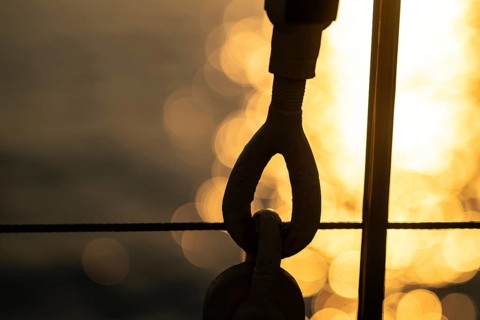 Part of the rigging of a sailing ship, anchoring, steel cable, back light, sunset, silhouette,