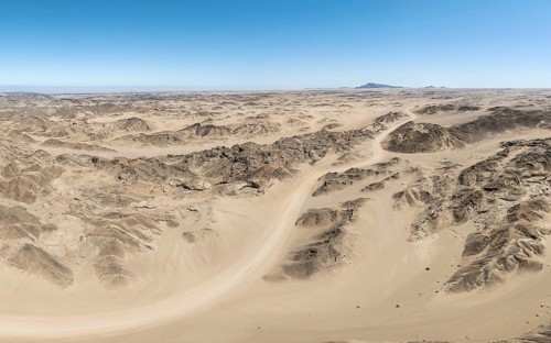 Aerial view, dry barren mountains in Moon Valley, rocky landscape ridged by erosion, Namib-Naukluft