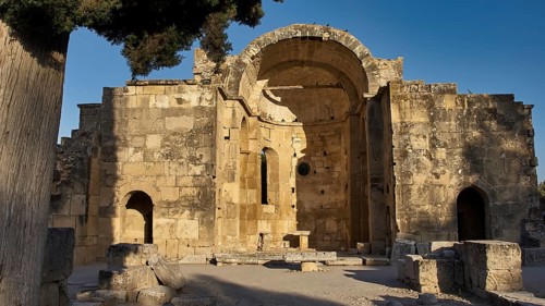Titus Basilica, Greece, ancient ruin with large arch and tree in the background, Gortyn, Gortyna,