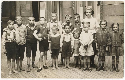 Children, backyard, twenties, big city, poverty, without shoes, barefoot, girls in similar clothes,