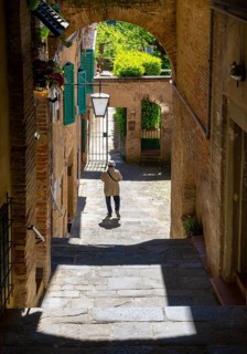 Tourists traveling in the small town of Pienza in Tuscany, Italy