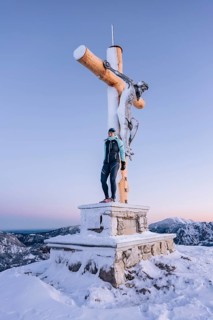 Summit bliss in the snow-covered winter landscape in the Tannheimer Tal in the Alps on the