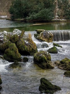 Small waterfall, winter in the English Garden, Munich, Bavaria, Germany