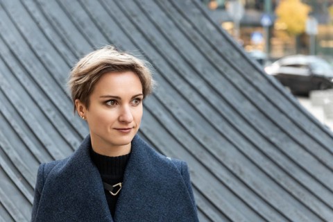 Portrait of an attractive short-haired blonde woman in the city in autumn. A woman with short light