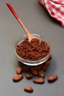 Cocoa powder in glass shell and cocoa beans