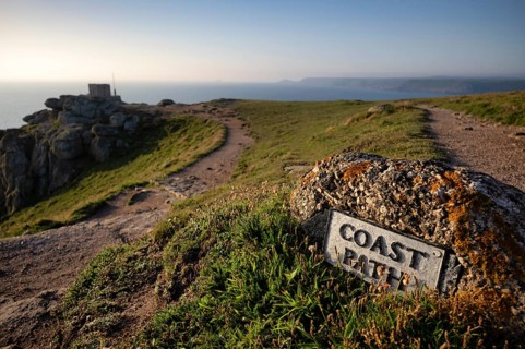 Signpost, sign on stone, cliffs with lichens, coastal footpath, coast path, public footpath, behind
