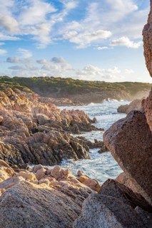 Landscape of the coastline with blue water at Marinedda Coast at sunset, Sardinia, Italy