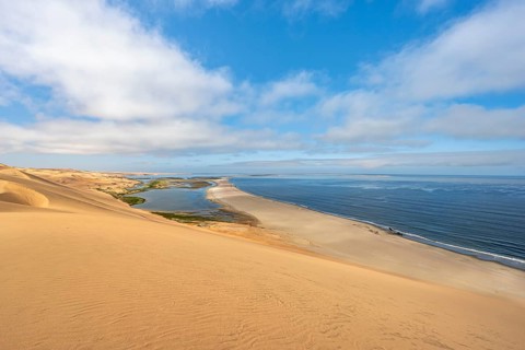 Sand dunes and sea, Atlantic coast and sandy desert with sea of dunes, view of lagoon at Sandwich