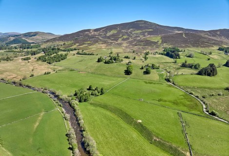 Aerial drone photo of agricultural landscape with meadows and pastures at the border of the Cairn