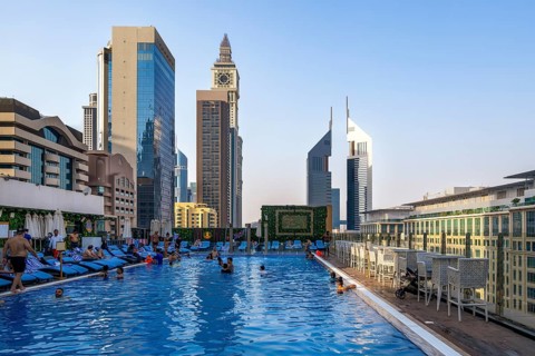 Swimming pool with view of Al Yaqoub Tower and Emirates Towers, Dubai, United Arab Emirates, UAE