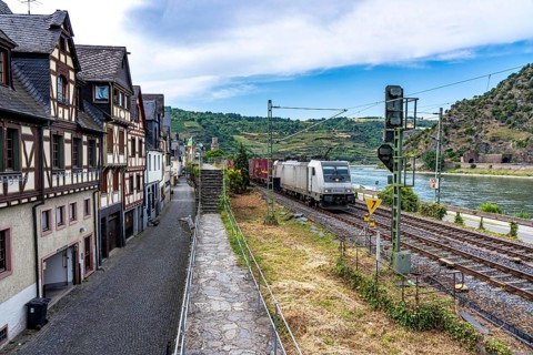 Freight train, in the Upper Middle Rhine Valley, runs directly in front of the residential