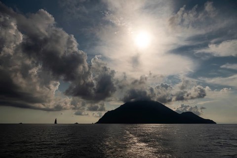 Silhouette of Filicudi Island, backlight, dramatic cloud atmosphere, Aeolian or Lipari Islands,