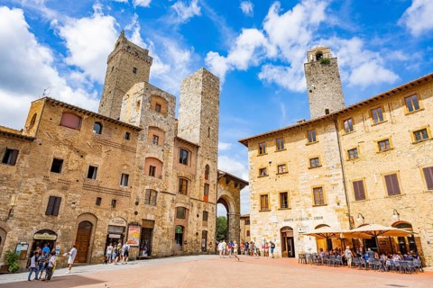 Towers of the old Town with historic buildings from Piazza della Cisterna at San Gimignano on a