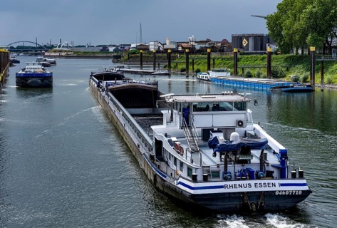 Freight ships in the port canal in the port of Duisburg-Ruhrort are waiting in front of the