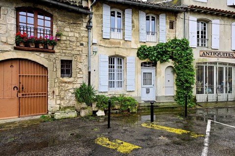 Green house facades in a district street in the city, Arles, Camargue, southern France, France