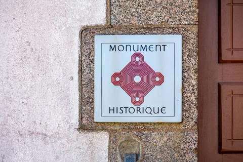 Sign with official logo for French cultural monuments Monument historique, historical monument at