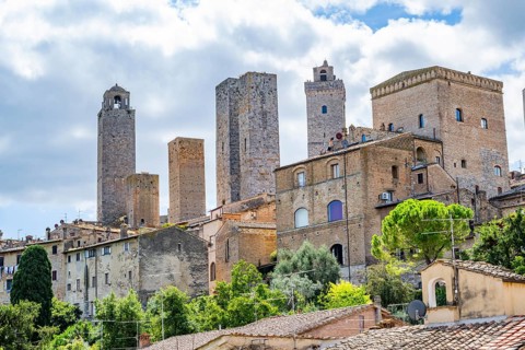 Towers of the old Town with historic buildings at San Gimignano on a sunny day, Tuscany, UNESCO