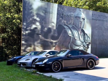 In the background, poster from Museum Aguntum with larger-than-life illustration of Gladiator looks