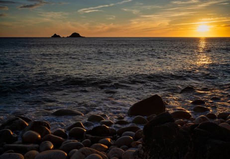 Evening, sunset at sea, in the background rock formation The Brisons, Cot Valley Beach, Porth